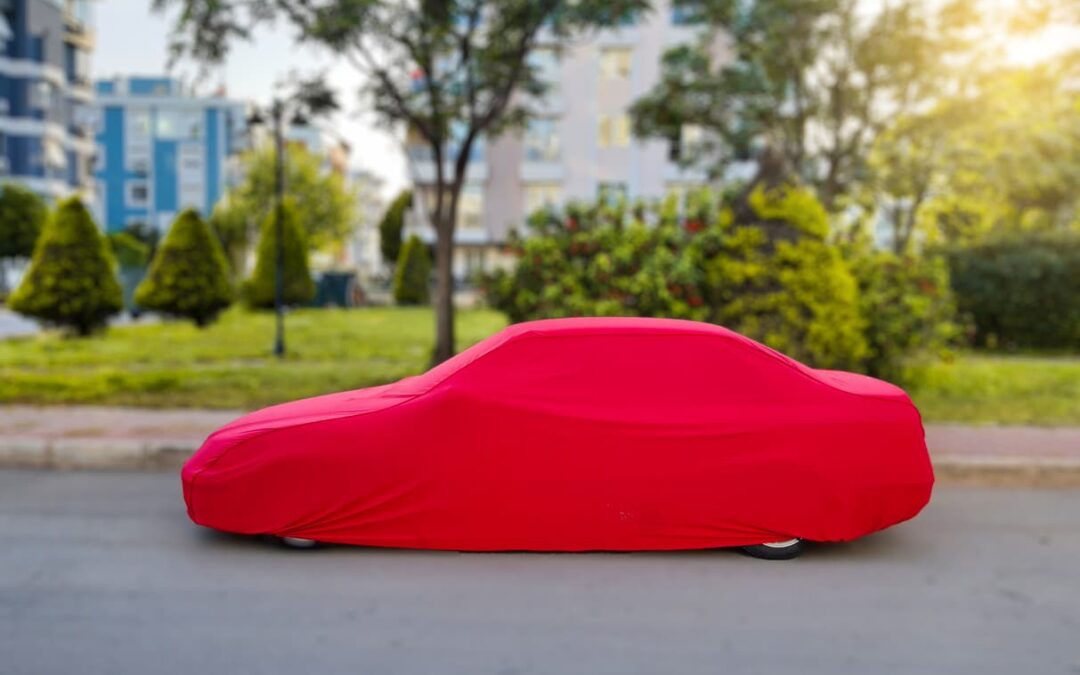 a car with a red cover draped over it