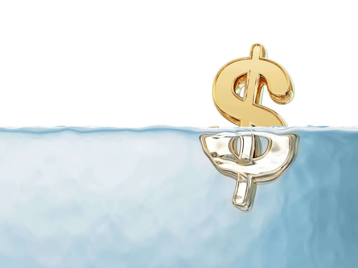 A golden dollar symbol floating in water