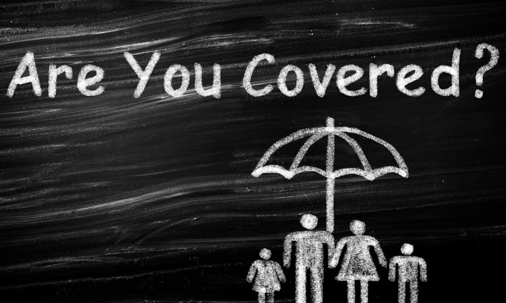 A drawing of a family with life insurance for children under an umbrella