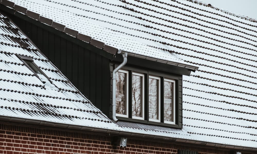 Upper exterior of a house covered in snow.