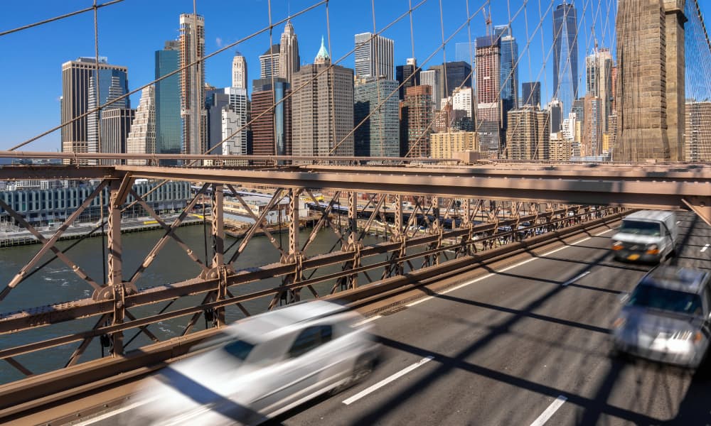Morning traffic rushing across the Brooklyn Bridge in New York City.